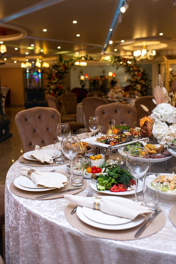 White Napkins, Beautifully Folded on Plates in a Restaurant. Restaurant