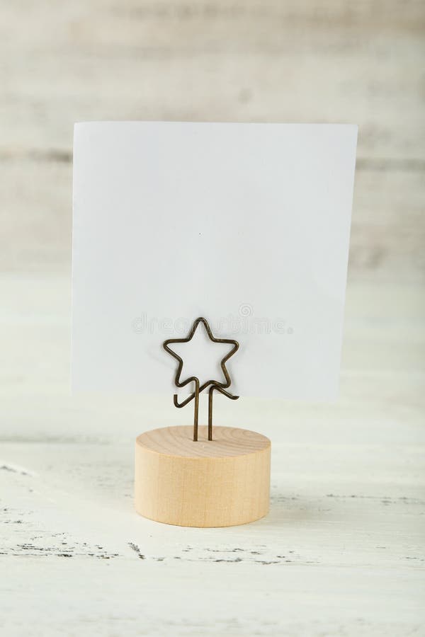 White note paper on a holder on white wooden background. stock images