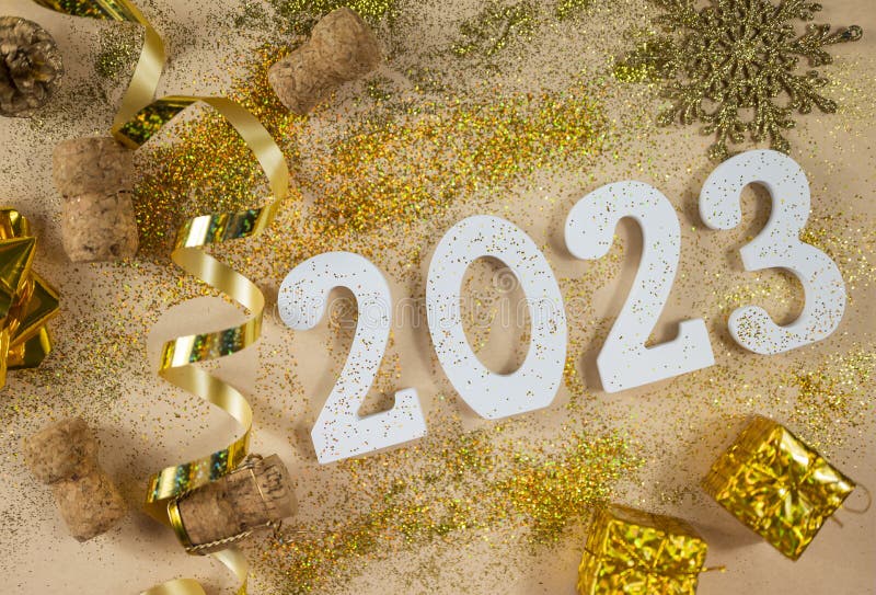 white numbers 2023 for the New Year holiday in December with glitter gold wooden cork