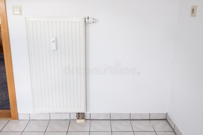 White painted woodchip wallpaper and heating at a wall