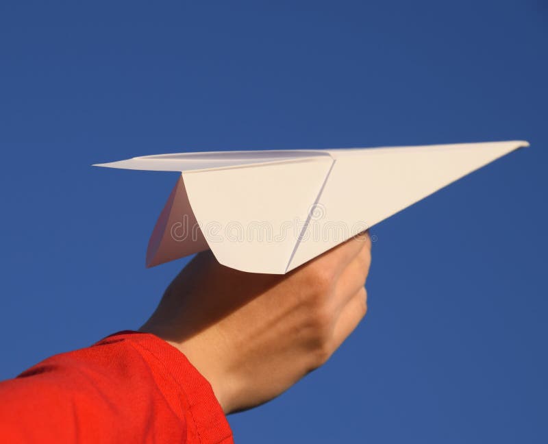 White Paper Airplane in Hand Against the Sky. a Symbol of Freedom on ...