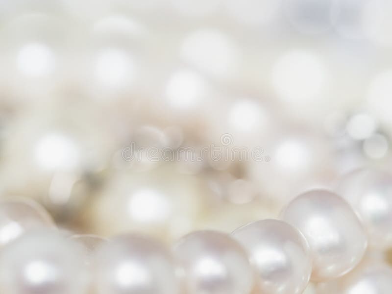 White pearls on the black silk as background, Stock image