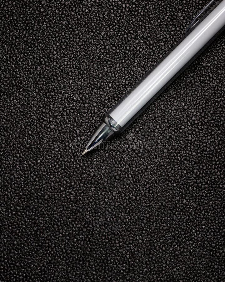 White Pen on Black Leather Background. Template of Ballpoint Pen for