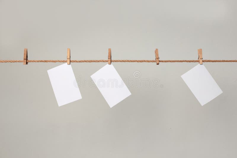 White photo paper. Hanging on a clothesline with clothespins.