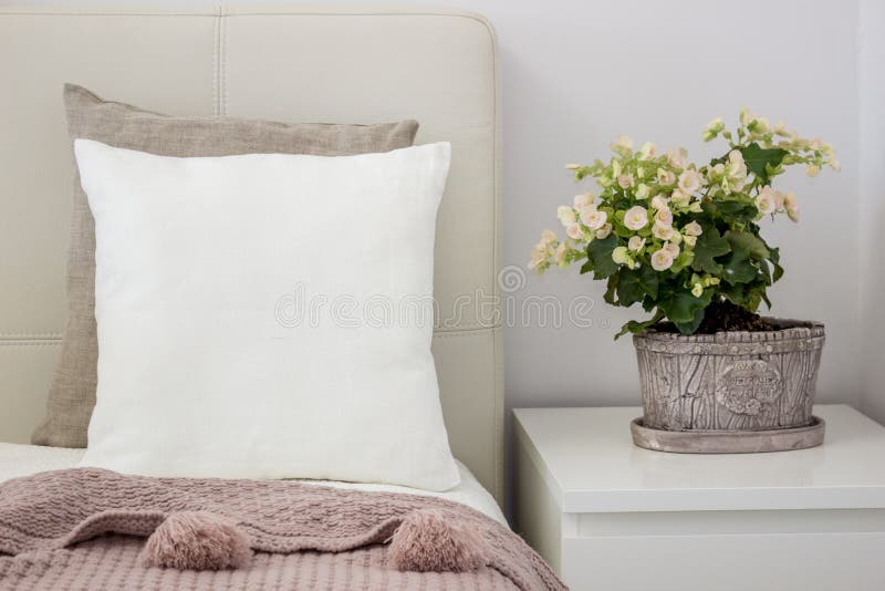 White pillow on bed in a cozy bedroom, Mockup