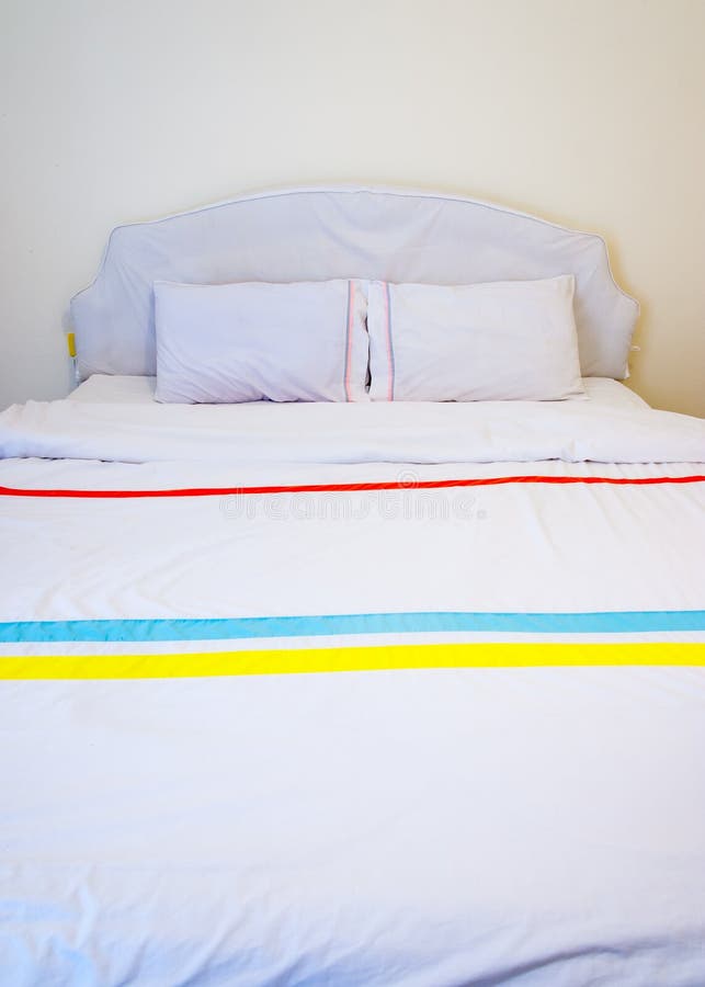 White pillows on a bed stock photo. Image of luxury, isolated 32515180