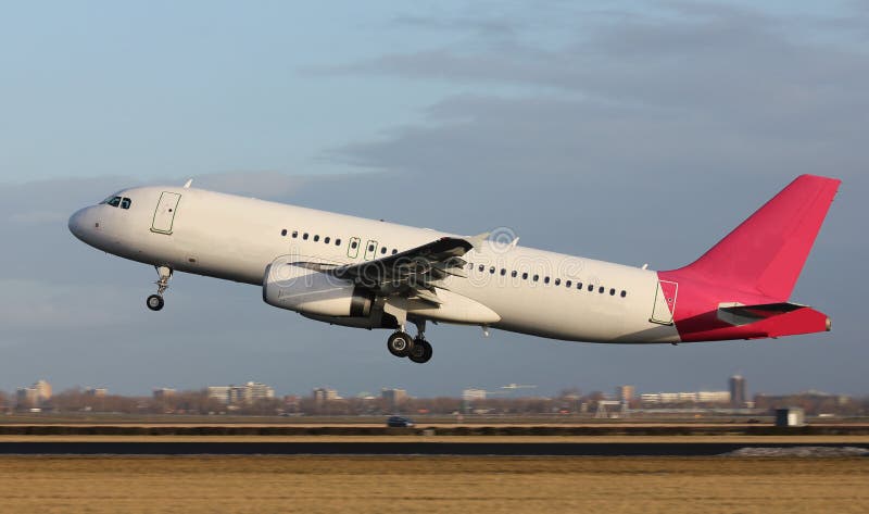 A white jet plane taking off from runway. A white jet plane taking off from runway