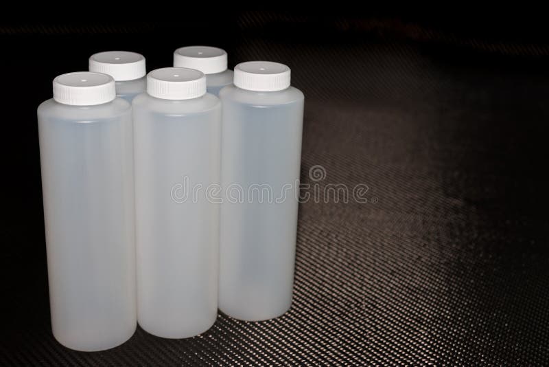White Plastic Containers With Lids On Carbon Fiber Stock Photo Image