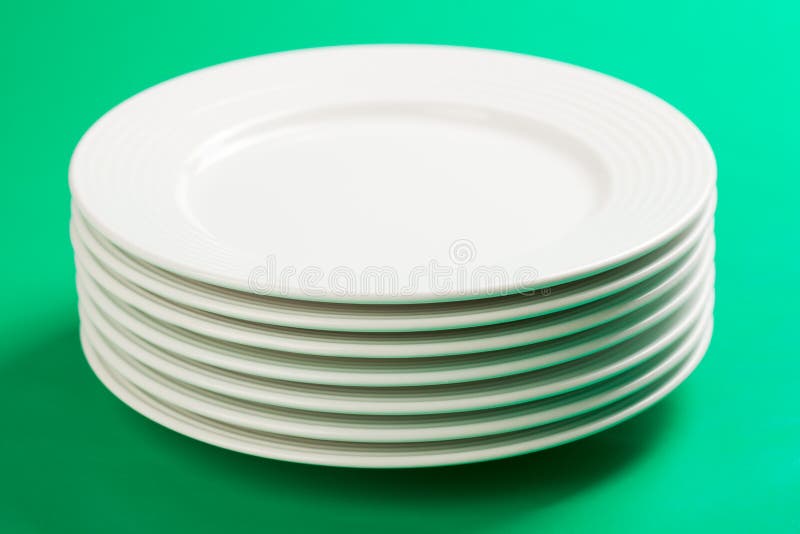 White plate on green background royalty free stock image