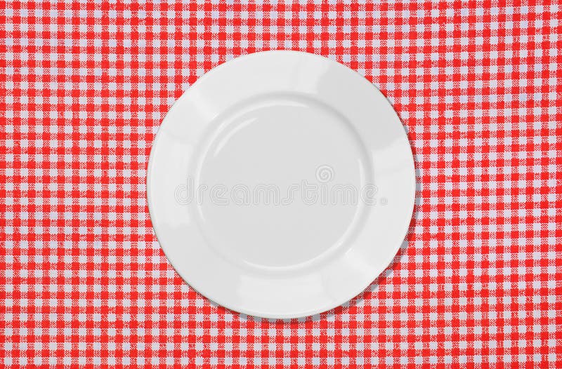 White plate on red and white tablecloth royalty free stock photography