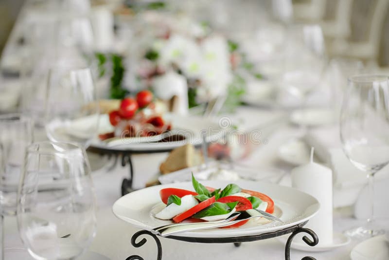 White plates are on the table in restaurant.