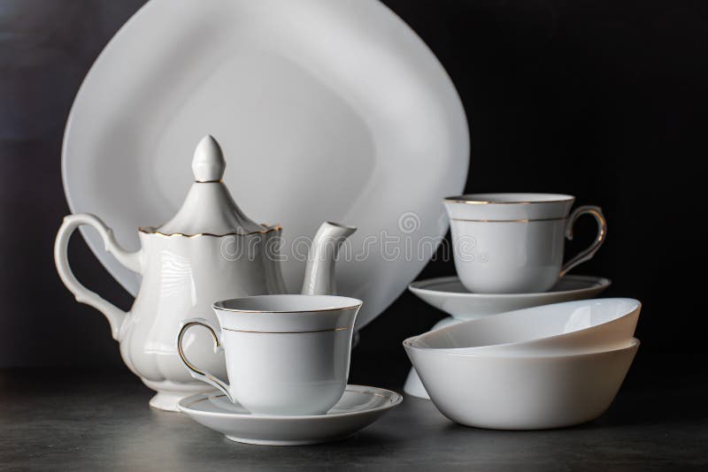 White Porcelain Tea Setfolded Cups And Saucers And Teapot Stock Photo