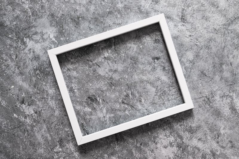 White rectangular picture frame mock-up with copy space for yout text or image on top of grey concrete background stock photography White rectangular picture frame mock-up with copy space for yout text or image on top of grey concrete background stock photography