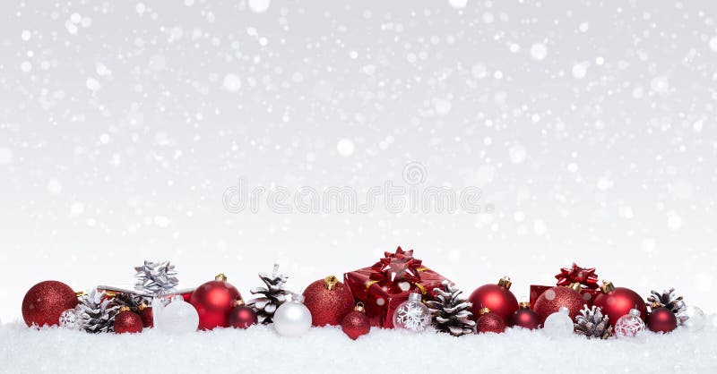 White and red christmas balls with xmas presents in a row isolated on snow royalty free stock image White and red christmas balls with xmas presents in a row isolated on snow royalty free stock image