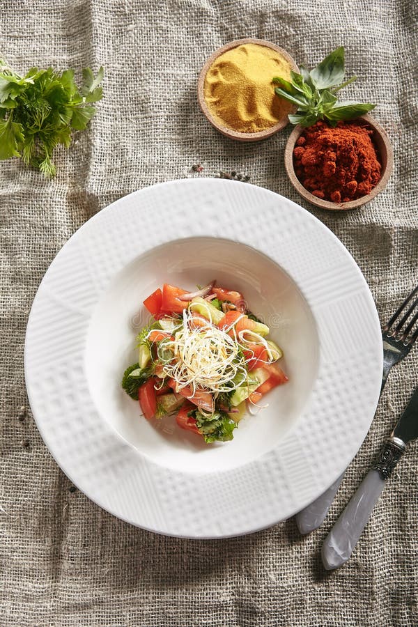 White Restaurant Plate of Vegetable Vegetarian Salad with Strips of Smoked Cheese