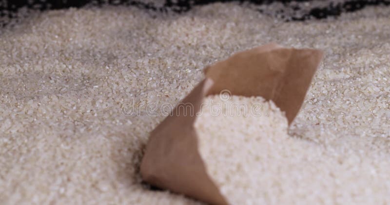 White Rice in the Bag Falls and Crumbles on the Table Stock Video