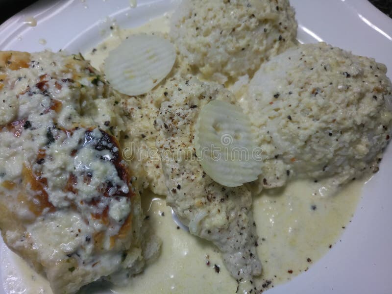 White Rice and Chicken Breast Covered in White Sauce Stock Photo
