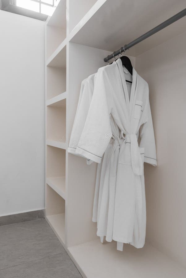 Bathrobe Hanger in Wardrobe. Four Purple Color Bathrobes on a Hangers