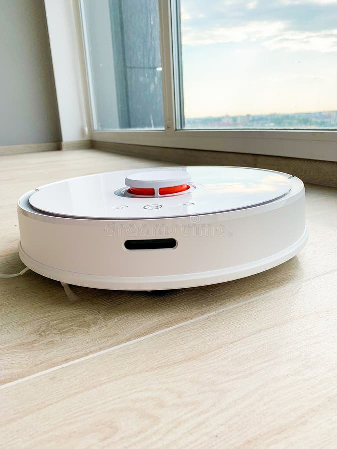 White Robot Cleaner Robot Vacuum Cleaner On Laminate Floor In