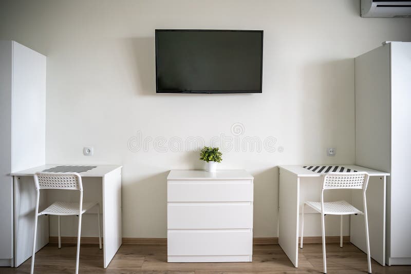 White Room Interior with TV on Wall, Two White Tables and Chairs