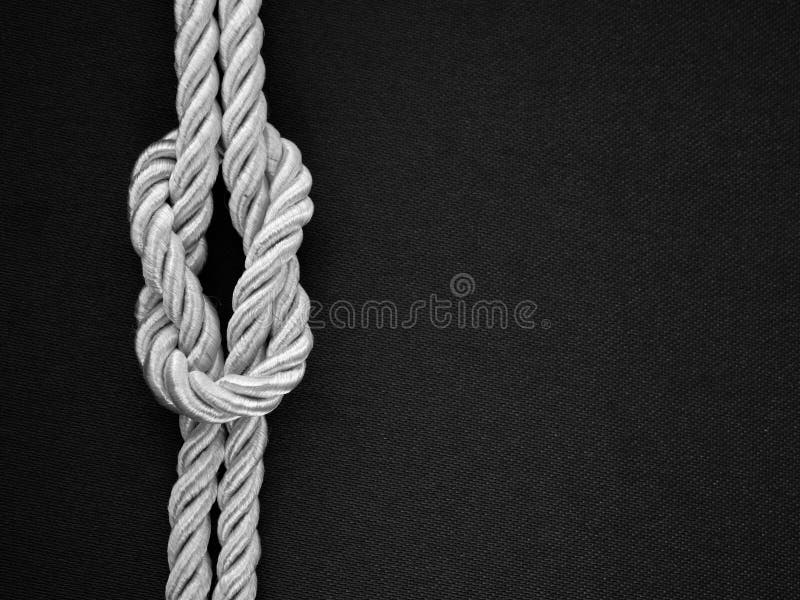 White rope tie a knot on the black