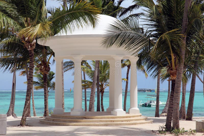 White rotunda for weddings on a tropical beach. The picture was taken at the Bavaro beach, Punta Cana, Dominican Republic. White rotunda for weddings on a tropical beach. The picture was taken at the Bavaro beach, Punta Cana, Dominican Republic