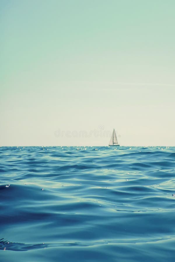 White Sailing Boat Sailing on the Horizon, Open Blue Sea Stock Image ...