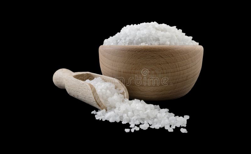 White salt crystals in wooden bowl and scoop isolated on black background. Spices and food ingredients.