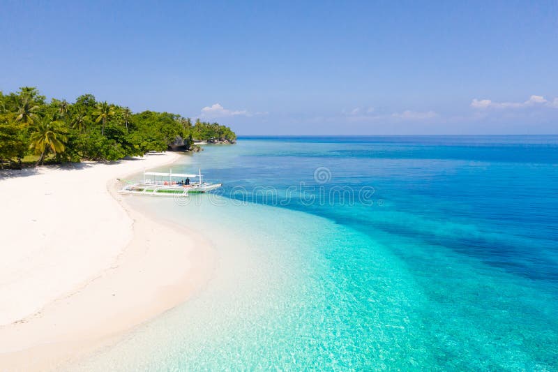 White sand beach and blue sea, view from above . Mahaba Island, Philippines. advertising concept