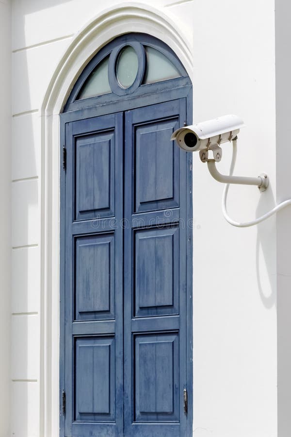 White Security Camera near Old Blue Wooden Window. Old cctv monitor stock images, royalty-free photos and pictures