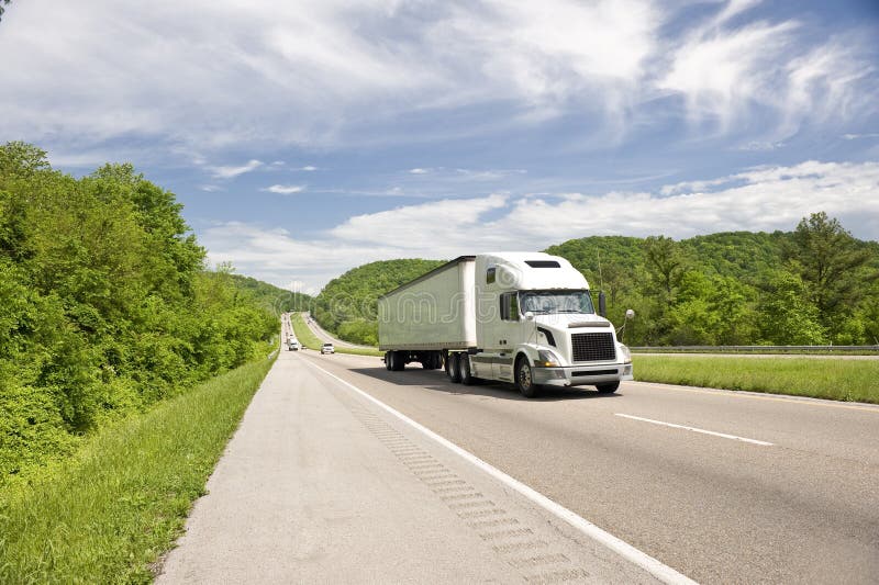 White Semi Truck On Highway In Springtime stock image