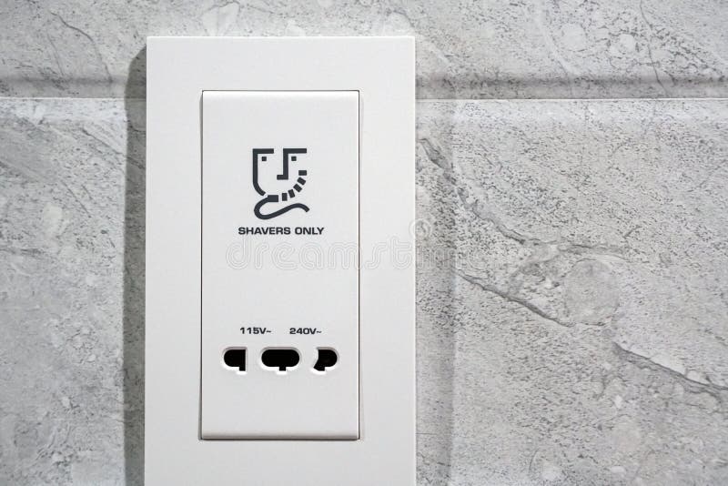 White Shavers only Sign Electrical Outlet in Restroom Stock Photo