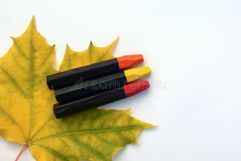 White sheet of paper with autumn maple leaf and colored pencils stock photos White sheet of paper with autumn maple leaf and colored pencils stock photos