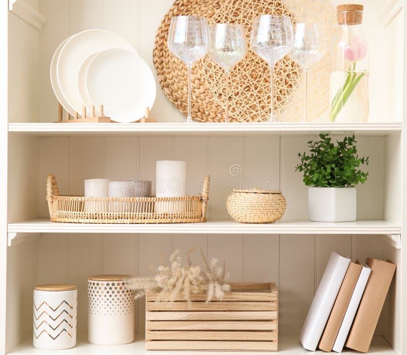 White shelving unit with dishware and decorative stuff