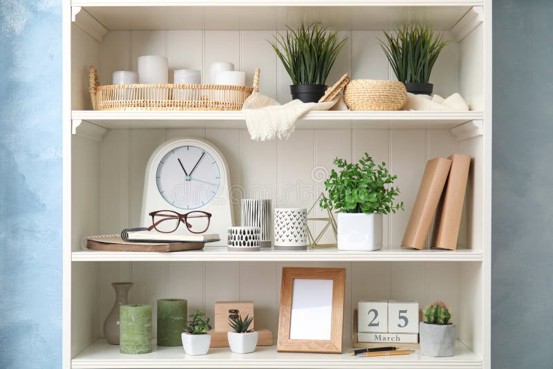 White Shelving Unit with Plants and Decorative Stuff Stock Image