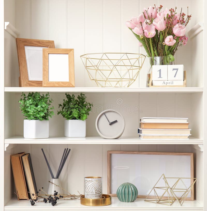 White Shelving Unit with Plants and Decorative Stuff Stock Photo