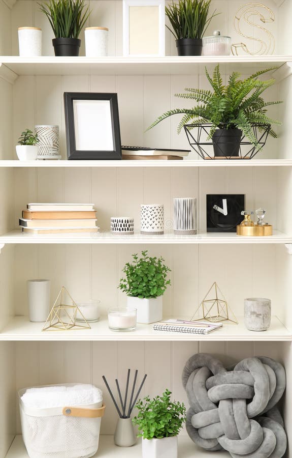 White Shelving Unit with Plants and Decorative Stuff Stock Image
