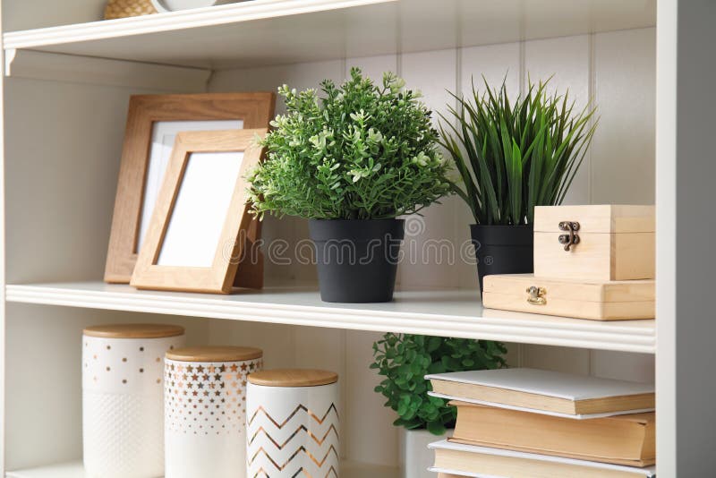 White Shelving Unit with Plants and Decorative Stuff Stock Photo
