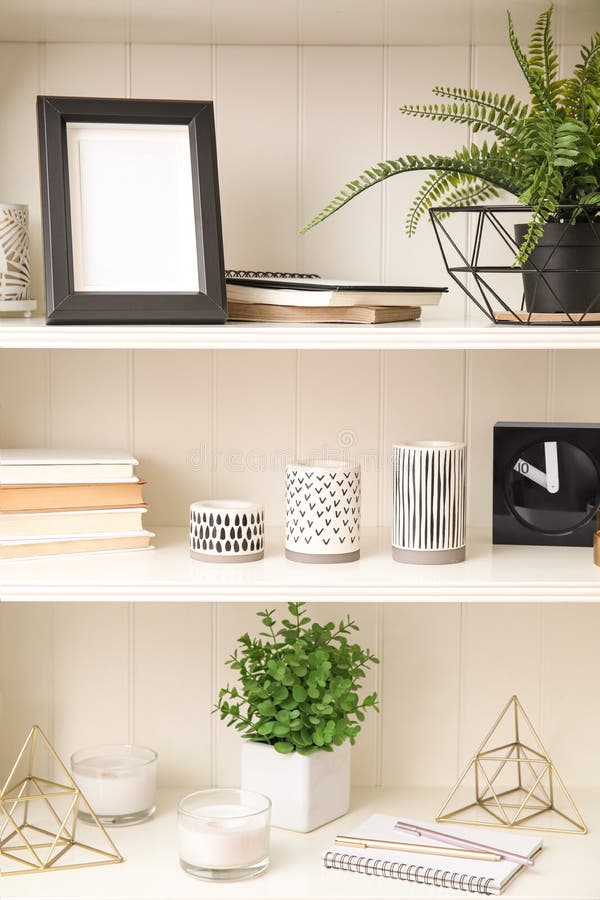 White Shelving Unit with Plants and Decorative Stuff Stock Photo