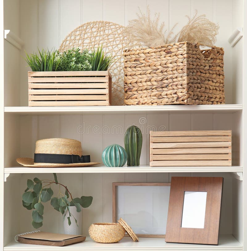 White Shelving Unit with Plants and Decorative Stuff Stock Photo