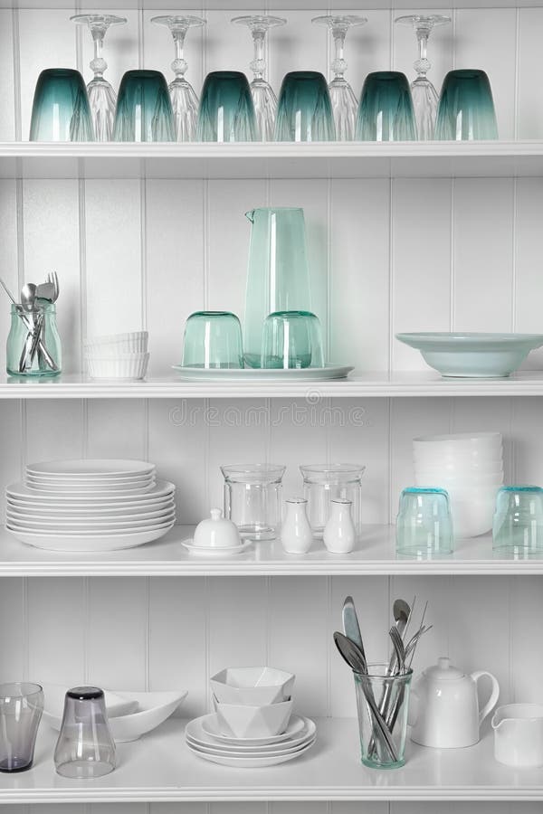 White shelving unit with set of dishware