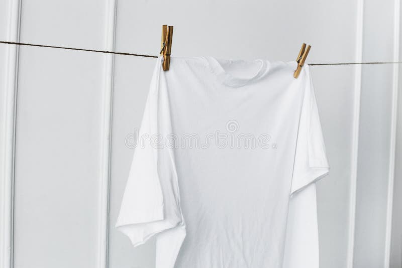 White shirt hanging by the wall