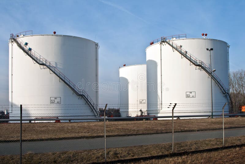 White silo tanks in a tank farm with blue sky