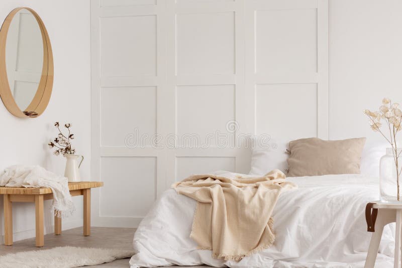 White simple bedroom design with mirror and bed with white sheets