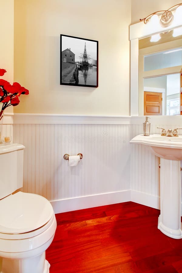 White Small Elegant Bathroom with Red Wood Floor. Stock Image Image