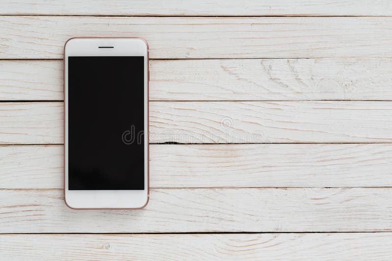 White Smartphone Iphone with Dark Screen on White Wood Texture