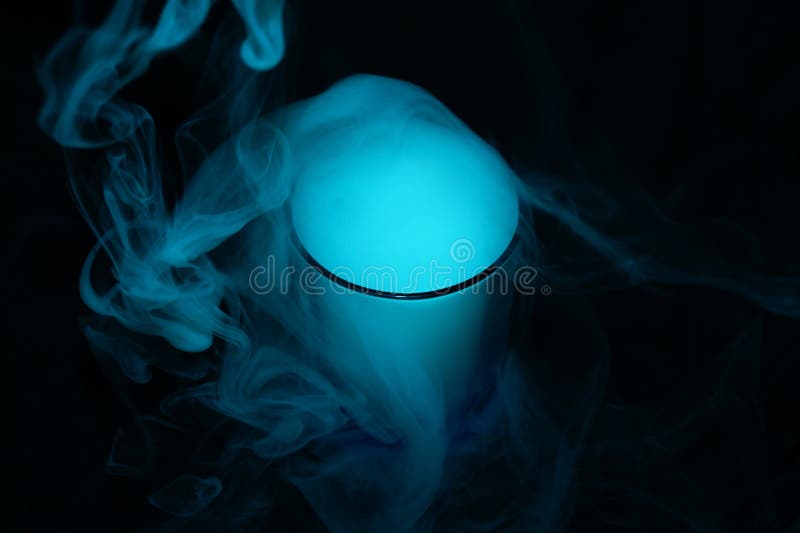 White smoke on black fabric background in glass. Smoke spreads over the background. Vaping culture, life without cigarettes. Conceptual image