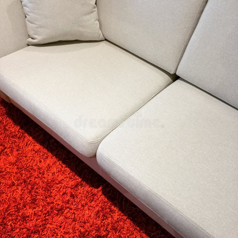 White sofa on red carpet stock photo. Image of detail 70909664