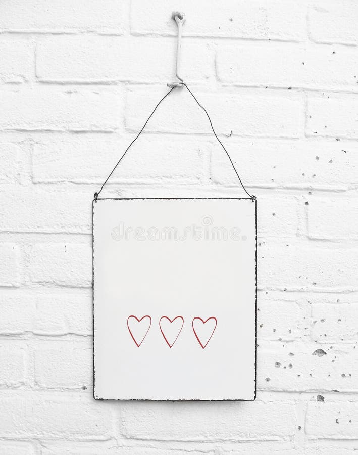 White square metal plate with cute red hearts and space for own text on white brick background stock photo White square metal plate with cute red hearts and space for own text on white brick background stock photo