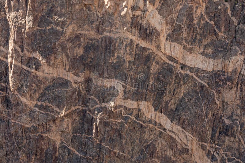 White Streaks in the Layered Rock Wall in Black Canyon Stock Photo